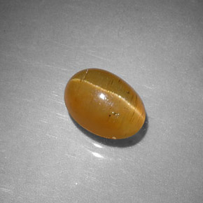 Apatita olho de gato laranja natural 1,43ct, corte oval, translúcido