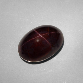 Granada estrela preto natural 25,18ct, corte oval, opaco