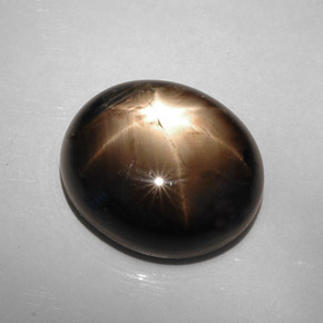 Safira estrela preto natural 22,73ct, corte oval, opaco