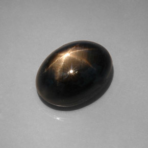 Safira estrela preto natural 12,08ct, corte oval, opaco